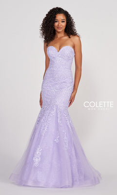 A woman stands against a plain backdrop wearing the Colette Pastel Strapless Lace Mermaid Prom Dress, featuring lace details and light purple embellishments.