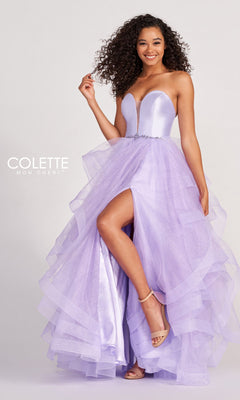 A woman stands and smiles against a plain background, wearing the Colette Glitter-Tulle Layered Long Prom Ball Gown—strapless, lavender, with a high slit and layered skirt. "Colette Mon Cheri" logo appears on the left.