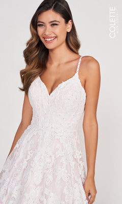 Smiling against a neutral background, a woman models the CL2008 Colette White & Pink Lace Long Prom Dress—an elegant gown with lace details and spaghetti straps, perfect for prom or any special occasion.