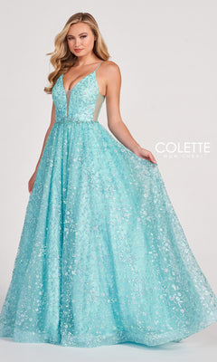 A woman stands against a plain light background, wearing the Backless Tulle Prom Ball Gown CL2016 with a sleeveless, floor-length silhouette, deep V-neckline, glitter print, and sparkling floral sequin embellishments.