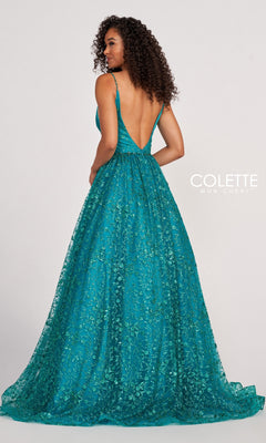 A woman showcases the Backless Tulle Prom Ball Gown CL2016 with glitter print, featuring a teal, floor-length design, deep V-back, and sparkling floral details, standing with her back to the camera.