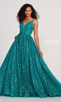 Woman wearing the Backless Tulle Prom Ball Gown CL2016 with glitter print, a deep teal, floor-length, sleeveless dress with sparkling details and a full skirt, posing in front of a plain background.