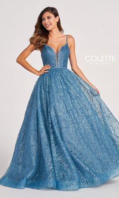A woman wearing the Colette CL2018 Deep V-Neck Glitter-Lace Ball Gown, with a fitted bodice, thin straps, and full skirt, stands against a plain background.