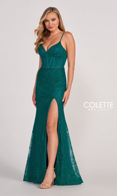 A woman poses against a plain background in the Colette CL2037 Long Lace Prom Dress with Beads—a fitted, teal, floor-length gown featuring spaghetti straps, a thigh-high slit, and beaded lace detailing.