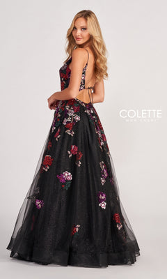 Woman in the Black Prom Dress CL2069 featuring multicolor floral appliques and an open back, standing sideways and looking over her shoulder.