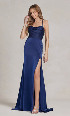 A woman in a Cowl-Neck Classic Prom Dress with a side slit, featuring a sleeveless, floor-length navy blue ruched design, poses against a neutral background, ready for her formal event.