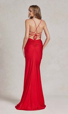 A woman wears the Backless Prom Dress with Beaded Floral Appliques, featuring a fitted silhouette, open back with crisscross straps, and floor-length red design, standing against a neutral background.