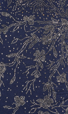 Close-up of the Sparkle Jersey Formal Dress: Ellie Wilde EW122028 in dark blue, featuring intricate silver bead and sequin embroidery in a formal floral pattern.