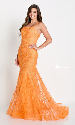 A woman models the Long Lace Mermaid Prom Dress with Strappy Back—fitted, floor-length, orange lace with thin straps and an open back—posing against a white background. “Ellie Wilde” appears beside her.
