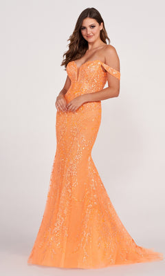 A woman in a lace-embroidered off-shoulder long mermaid gown stands against a plain light background. This fitted, floor-length dress is perfect for making a bold statement at any event.