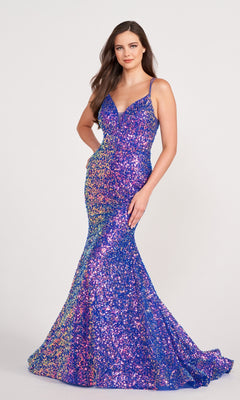 A woman stands against a plain light background wearing an Ellie Wilde Long Stretch-Sequin Prom Dress with a fitted, floor-length design and thin straps.