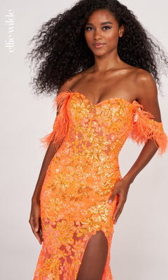 A woman poses confidently against a light background in the Feather-Trim Off-Shoulder Long Sequin Prom Dress—a bright orange gown with sequins, feathered sleeves, and a thigh-high slit.