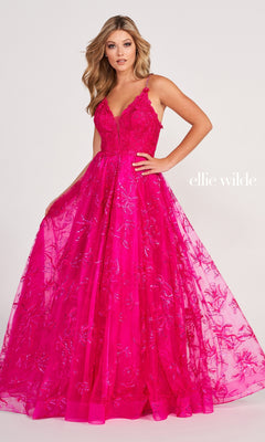 A woman poses in the Tulle Embroidered A-Line Prom Dress by Ellie Wilde, a bright pink, floor-length gown with floral embroidery, thin shoulder straps, a fitted bodice, and flared skirt—perfect for an elegant prom look.