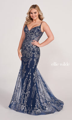 A woman stands against a plain background wearing the Sequin and Glitter Mermaid Prom Dress by Ellie Wilde—a navy blue, floor-length, sleeveless gown with silver embroidery that is form-fitting and flares at the bottom.