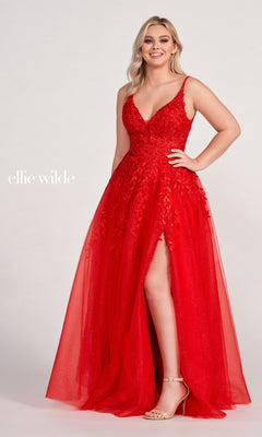 A woman wears the Glitter-Tulle Long Ellie Wilde Prom Dress EW34089, featuring a sleeveless design, deep V-neckline, crystal beading, embroidery, floor-length tulle skirt, and high slit, standing against a plain background.