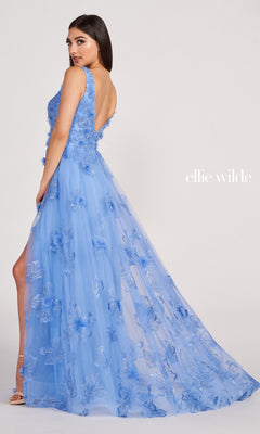 A woman poses in the Ellie Wilde Faux-Wrap Embroidered-Lace Prom Dress, featuring light blue lace, a deep V-back, high slit, and sheer overlay. The plain background displays the ellie wilde logo.