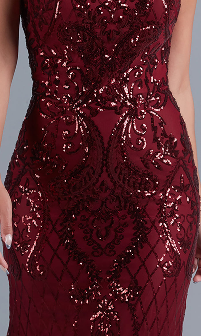 A person wearing the PromGirl Statement-Back Long Sequin Prom Dress, a sleeveless, fitted burgundy gown adorned with intricate sequin patterns and beadwork.