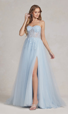 A woman in a Corset-Bodice Long Pastel Prom Dress featuring a sheer lace bodice, spaghetti straps, high slit, and silver heels poses against a neutral background.