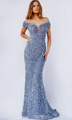 A woman stands against a plain light background wearing the Jovani Sequin Off-the-Shoulder Prom Dress, a fitted gown adorned with shimmering silver sequins.