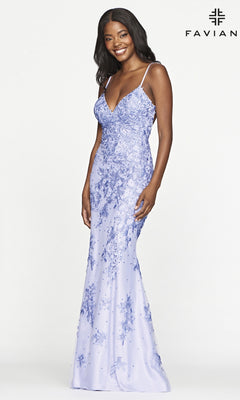 A woman stands smiling in a fitted, floor-length lavender Faviana Lace Embroidery Long Backless Prom Dress with floral details and thin straps. The "FAVIAN" logo appears in the top right corner.