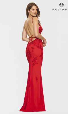 A woman wears a Strappy-Back Long Light Pink Prom Dress by Faviana with thin straps and a fitted silhouette, standing against a plain white background.