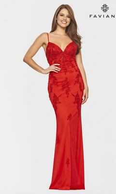 Woman wearing a Strappy-Back Long Light Pink Prom Dress by Faviana with floral lace details and thin straps, standing and smiling against a plain white background. "FAVIAN" appears in the top right corner.