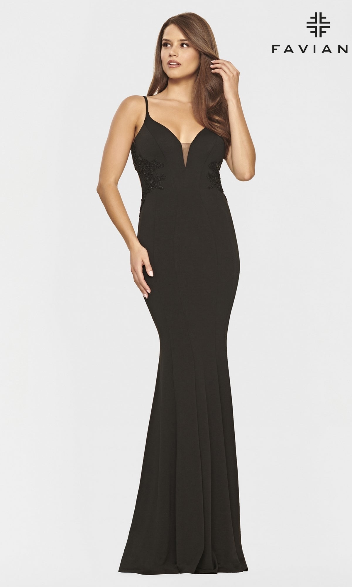 A woman wears a sleeveless, floor-length Faviana long navy blue prom dress with gold bead detailing and a deep V-neckline, standing against a plain white background with the Faviana logo.