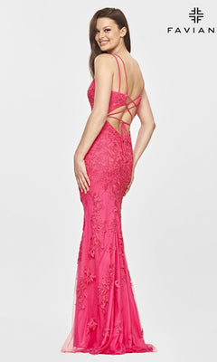 A woman poses in the Faviana S10813 Long Lace Hot Pink Prom Dress, featuring floral embroidery and crisscross straps on the open back. The "FAVIANA" logo appears in the top right corner.