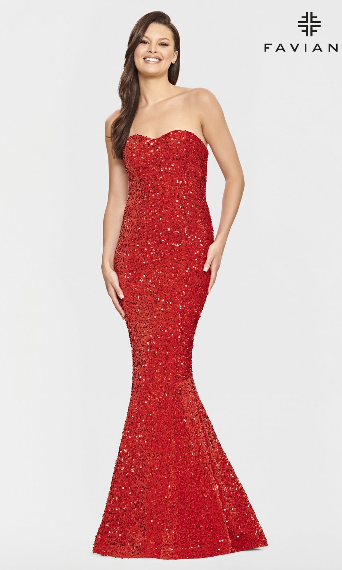 A woman smiles against a white background, modeling the Faviana Strapless Sweetheart Long Sequin Prom Gown with a flared hem. The word 