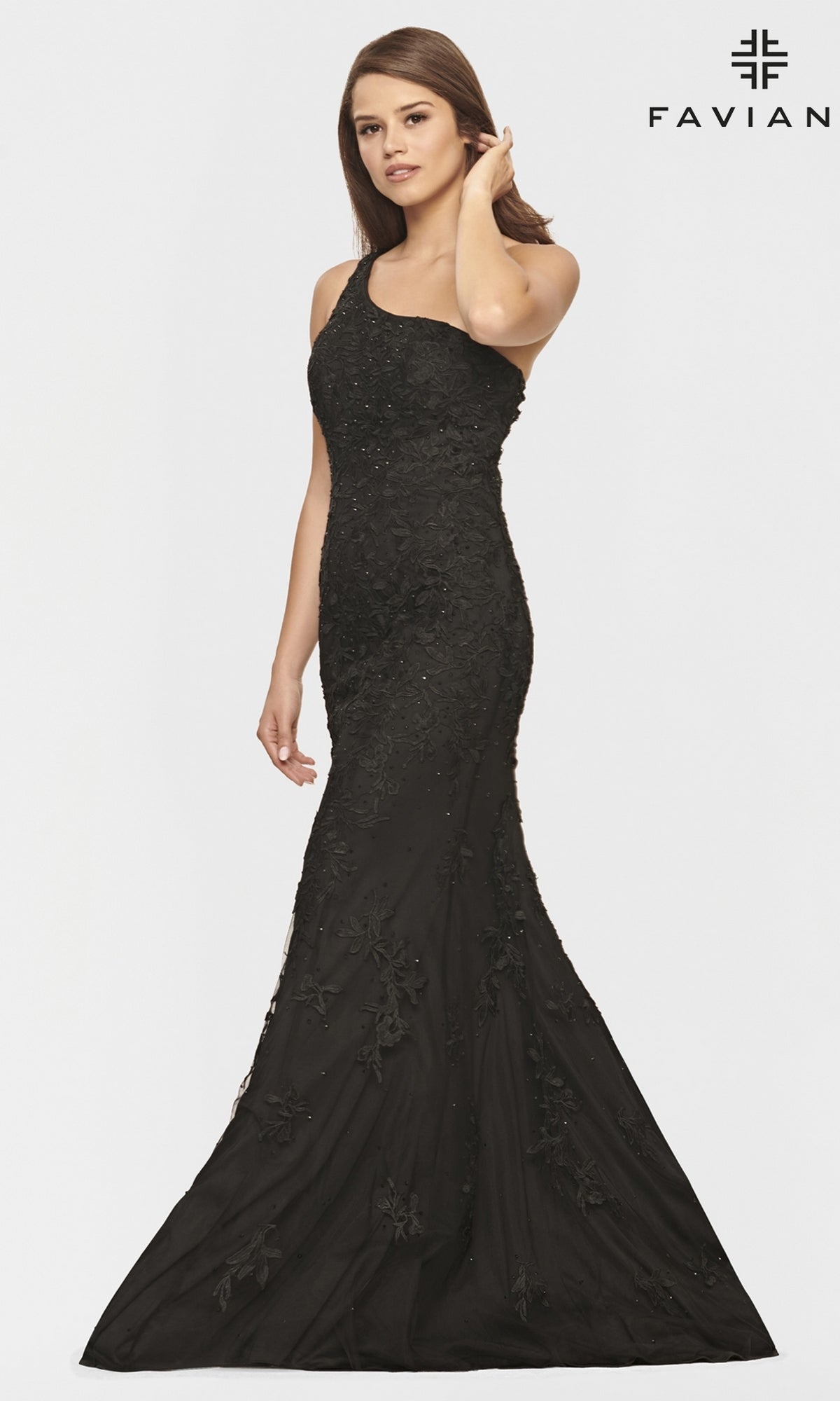 A woman models the One-Shoulder Faviana Long Lace Formal Dress, a fitted, floor-length black gown with an asymmetrical neckline and floral embroidery, standing against a plain white background with the 