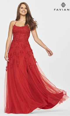 A woman models the Faviana Strappy-Back Long Lace A-Line Prom Dress in red, posing gracefully against a plain background with the Faviana logo displayed in the top right corner.