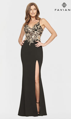 A woman wears the Black and Gold Faviana Long Prom Dress S10853—a sleeveless evening gown with gold floral appliques on the bodice and a thigh-high slit—standing against a plain white background with the Faviana logo.