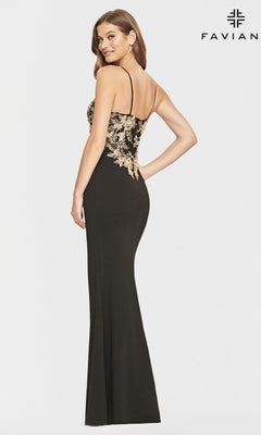 A woman wearing the Black and Gold Faviana Long Prom Dress S10853, featuring elegant gold floral appliques.
