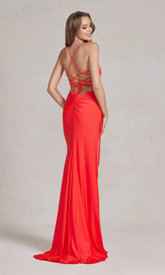 A woman models the Strappy-Back Affordable Long Prom Dress in bright red, featuring crisscross straps and ruched detailing, as she stands and glances over her shoulder.
