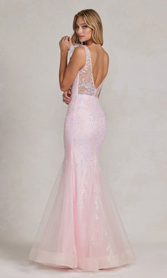 A woman, back slightly turned, wears the Feather-Strap Long Prom Dress: Nox Anabel T1208—a light pink, floor-length glitter mermaid style with a sheer lace back and subtle shimmer.
