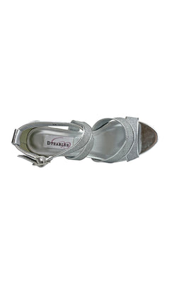 The Amber Silver Prom Shoes by Touch Ups 54716 are silver open-toe sandals with an ankle strap and buckle, seen from above. Featuring a chic 2.75-inch heel, they're perfect for prom, offering elegant comfort throughout the night.