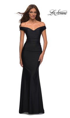 A woman wears the La Femme Sheer-Back Off-Shoulder Long Prom Dress in black, featuring a fitted silhouette and slight mermaid flare—a stunning choice for prom. The "La Femme" logo appears in the top right corner.