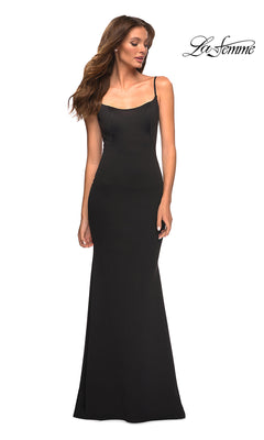 Woman in a Long Sleek and Simple Prom Dress by La Femme in black, featuring thin straps, stands against a white background with the "La Femme" logo at the top right.