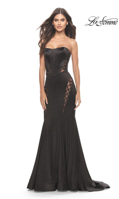 A woman models the La Femme Strapless Long Black Dress with Cut Outs, featuring a fitted bodice and lace-up sides, against a plain white background. The elegant La Femme logo appears in the top right corner.