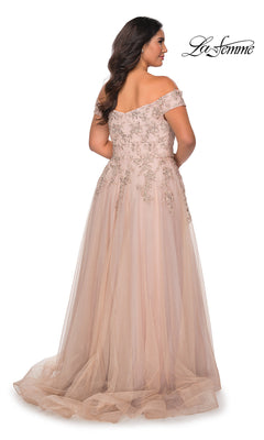A woman is seen from the back in an off-the-shoulder, floor-length blush La Femme Plus-Size Prom Ball Gown featuring beaded embroidery and a tulle skirt. The La Femme logo appears in the top right corner.