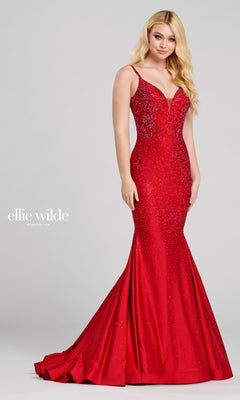 A woman poses in the Ellie Wilde Beaded Mermaid Prom Dress with Cut Out, a fitted floor-length gown with thin straps, sparkling embellishments, a v-neckline, and a classic mermaid silhouette.