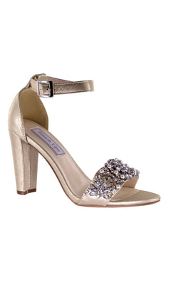 Felicity Nude Prom Shoes by Touch Ups 4293 feature a 3.25-inch heel, ankle strap, open toe, and decorative gemstones on the front strap—perfect for adding sparkle to your look.