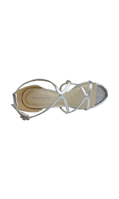 The Silver Lennox Platform Sandal by Touch Ups 4460 features crisscross straps, a buckle closure, and a 4-inch heel. Viewed from above, it has an elegant open-toe design perfect for elevating any outfit.