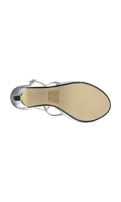 Top view of the sole of the Silver Lennox Platform Sandal by Touch Ups 4460, featuring a smooth beige bottom, silver upper straps, and care instructions printed near the arch.