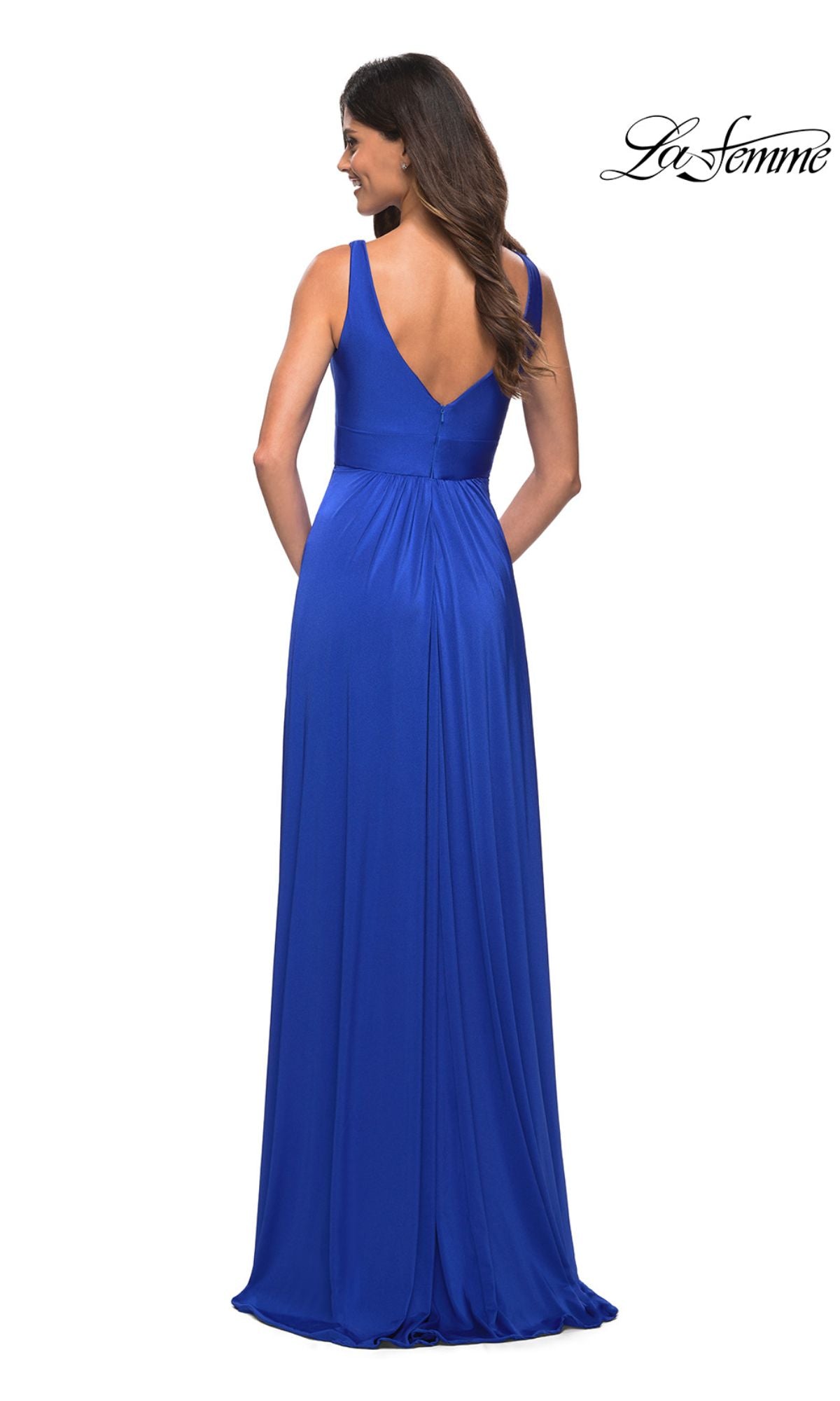 A woman in a sleeveless, floor-length royal blue La Femme Simple Long A-Line Formal Dress with a deep V-back stands with her back to the camera.