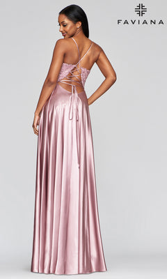 A woman in the Faviana Lace-Bodice Long A-Line Prom Dress, featuring a lace-up open back and subtle embroidered lace details, looks over her shoulder. Faviana logo appears in the top right corner.